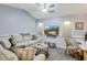 Cozy living room with comfortable seating, natural light, and a ceiling fan for added comfort at 1 Sun Ct., Carolina Shores, NC 28467