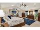 Large primary bedroom featuring ceiling fans, windows and dressers with a blue rug at 1 Sun Ct., Carolina Shores, NC 28467