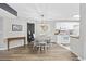 Dining area featuring a chandelier, seating for six, a wooden floor and adjacent kitchen at 100 Spanish Oak Ct. # H, Surfside Beach, SC 29575