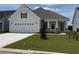 Charming single-story home featuring a two-car garage, manicured lawn, and craftsman-style details at 1067 Laconic Dr., Myrtle Beach, SC 29588