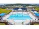 Aerial view showcasing the community pool area with ample seating, palm trees, and a clubhouse nearby at 1067 Laconic Dr., Myrtle Beach, SC 29588