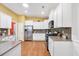Spacious kitchen with white cabinetry, stainless appliances, and hardwood floors at 110 Summerlight Dr., Murrells Inlet, SC 29576