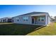 Spacious backyard with lush lawn, covered patio, and views of neighboring homes at 1110 Black Lake Way, Conway, SC 29526