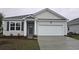 Charming single-story home with a two-car garage, light siding, and a well-maintained lawn at 1110 Black Lake Way, Conway, SC 29526