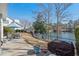 A patio sits next to a backyard, featuring a lake view and black fence at 118 Gully Branch Ln. # 3, Myrtle Beach, SC 29572