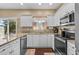Bright kitchen featuring granite countertops, white cabinetry, and stainless steel appliances at 118 Gully Branch Ln. # 3, Myrtle Beach, SC 29572
