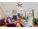 Bright living room with fireplace, ceiling fan, and hardwood floors, offering a comfortable and stylish space at 118 Gully Branch Ln. # 3, Myrtle Beach, SC 29572