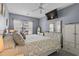 Cozy bedroom with calming blue walls, a ceiling fan, and comfortable furnishings at 118 Gully Branch Ln. # 3, Myrtle Beach, SC 29572