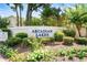 Arcardian Lakes community sign with colorful flowers and lush greenery, creating a welcoming and attractive entrance at 118 Gully Branch Ln. # 3, Myrtle Beach, SC 29572
