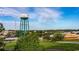 Elevated view of town featuring a water tower, mature trees and a mix of buildings on a partly cloudy day at 1434 Porchfield Dr., Conway, SC 29526