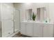 Modern bathroom with a large glass shower and double sink vanity with bright white cabinets at 1434 Porchfield Dr., Conway, SC 29526