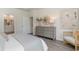 Bedroom featuring stylish grey dresser, round mirror, decor, accent chair, and modern neutral decor at 1434 Porchfield Dr., Conway, SC 29526