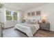 Stylishly staged bedroom with decorative pillows and luxurious bedding, enhanced by natural light from a large window at 1434 Porchfield Dr., Conway, SC 29526