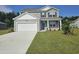 Charming two-story home with gray siding, white trim, a two-car garage, and a well-manicured front lawn at 1434 Porchfield Dr., Conway, SC 29526