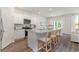 Well-lit kitchen showcases white cabinets, stainless steel appliances, granite countertops, and a cozy breakfast bar at 1434 Porchfield Dr., Conway, SC 29526