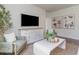 Inviting living room featuring a large TV, stylish furniture, neutral tones, and wood-look floors, creating a comfortable atmosphere at 1434 Porchfield Dr., Conway, SC 29526