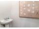 Clean powder room featuring a stylish pedestal sink and a large piece of artwork at 1434 Porchfield Dr., Conway, SC 29526