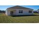 View of the home's backyard with a covered patio, green grass, and the rear exterior of the home at 1438 Porchfield Dr., Conway, SC 29526