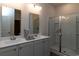 Bright bathroom features a double sink vanity, modern fixtures, and a glass-enclosed shower for convenience at 1438 Porchfield Dr., Conway, SC 29526