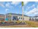 Cozy backyard featuring a screened porch, palm tree, and landscaped garden beds at 166 New Paradise Way, Myrtle Beach, SC 29588
