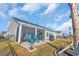 View of a private backyard with a screened-in porch, patio, and well maintained lawn at 166 New Paradise Way, Myrtle Beach, SC 29588