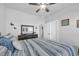 Bright bedroom featuring a rustic dresser, ceiling fan, and nautical themed decorations at 166 New Paradise Way, Myrtle Beach, SC 29588