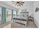 Comfortable bedroom with a king bed, carpet, ceiling fan, and a decorative coastal painting at 166 New Paradise Way, Myrtle Beach, SC 29588