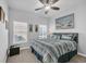 Comfortable bedroom with a queen bed, carpet, ceiling fan and a decorative coastal painting at 166 New Paradise Way, Myrtle Beach, SC 29588