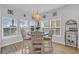 Cozy dining area with lots of natural light, a chandelier, and views of the backyard at 166 New Paradise Way, Myrtle Beach, SC 29588