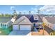 Beautiful two-story home with attached two-car garage, brick accents, and a well-manicured lawn at 166 New Paradise Way, Myrtle Beach, SC 29588