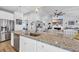 Bright kitchen features granite countertops, stainless steel appliances, and a view into the living room at 166 New Paradise Way, Myrtle Beach, SC 29588