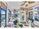 Relaxing screened-in porch featuring comfortable seating, ceiling fans, and view of the lake at 166 New Paradise Way, Myrtle Beach, SC 29588