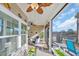 Relaxing screened-in porch featuring comfortable seating, ceiling fan, TV, and view of the backyard at 166 New Paradise Way, Myrtle Beach, SC 29588