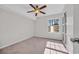 Sun-filled bedroom with ceiling fan, carpeted floor, and a window showcasing natural light at 1915 Bent Grass Dr. # E, Surfside Beach, SC 29575