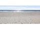 Wide sandy beach featuring gentle waves and open space for recreation at 2005 Havens Dr., North Myrtle Beach, SC 29582