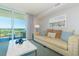 Comfortable living room with stylish decor, a plush sofa, and sliding glass doors to the balcony and views at 2151 Bridge View Ct. # 2-902, North Myrtle Beach, SC 29582