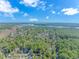 An aerial view showcases the community's lush landscaping and stunning waterways under a partly cloudy sky at 2166 Marion Circle, Little River, SC 29566