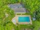 Aerial view of the community pool with ample seating surrounded by lush green landscaping and mature trees at 2166 Marion Circle, Little River, SC 29566