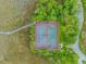 Aerial view of community tennis courts surrounded by lush green landscaping and mature trees at 2166 Marion Circle, Little River, SC 29566