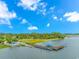 Aerial view of boat dock and parking area surrounded by lush landscaping and mature trees at 2166 Marion Circle, Little River, SC 29566