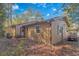 Home's backyard features a well-manicured lawn, beautiful foliage, and a golf cart parked in the driveway at 2166 Marion Circle, Little River, SC 29566