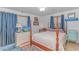This is a bedroom with a four poster bed, two windows and an area with a desk and a blue accent chair at 2166 Marion Circle, Little River, SC 29566