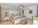 Inviting main bedroom with a ceiling fan, hardwood floors, and sliding barn door at 2166 Marion Circle, Little River, SC 29566