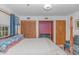 This bedroom has a four poster bed in front of two closets, one of which has pink painted interior walls at 2166 Marion Circle, Little River, SC 29566