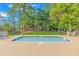 Small pool with seating and a playground in the background surrounded by lush green landscaping and bright blue sky at 2166 Marion Circle, Little River, SC 29566