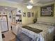 Comfortable bedroom area with a queen-size bed, ceiling fan, and kitchenette in the background at 2204 S Perrin Dr. # 3, North Myrtle Beach, SC 29582
