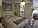 Relaxing bedroom features a queen bed, ceiling fan, and a tranquil view at 2204 S Perrin Dr. # 3, North Myrtle Beach, SC 29582