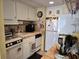 Efficient kitchen featuring white cabinets, tile countertops, and essential appliances at 2204 S Perrin Dr. # 3, North Myrtle Beach, SC 29582
