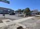 Exterior view of the parking area with a multi-colored condominium in the background at 2204 S Perrin Dr. # 3, North Myrtle Beach, SC 29582