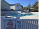 Community pool area with white fencing, lounge chairs, and well-maintained grounds at 2204 S Perrin Dr. # 3, North Myrtle Beach, SC 29582